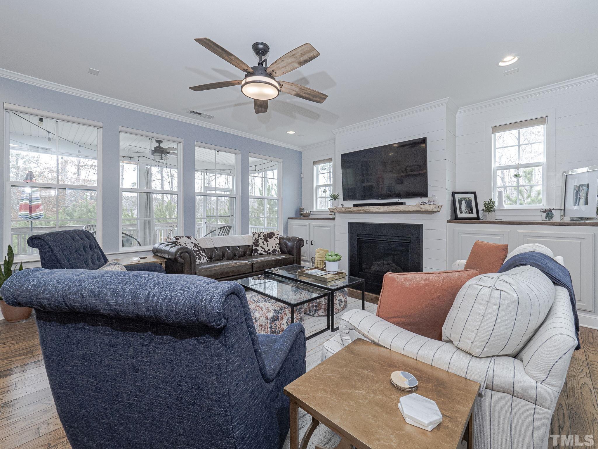 1990 Mostyn Lane Apex, NC 27502 - Photo 9 of 41 a living room with furniture a flat screen tv and a fireplace