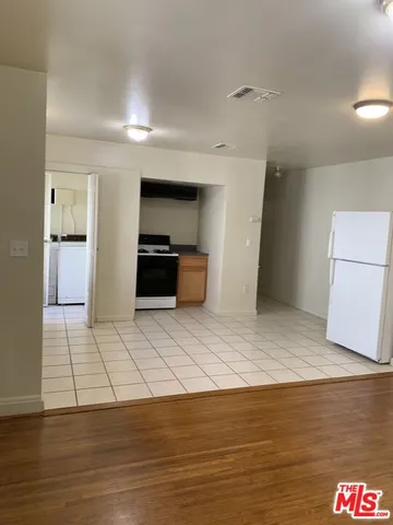 a kitchen with stainless steel appliances a refrigerator and a stove top oven