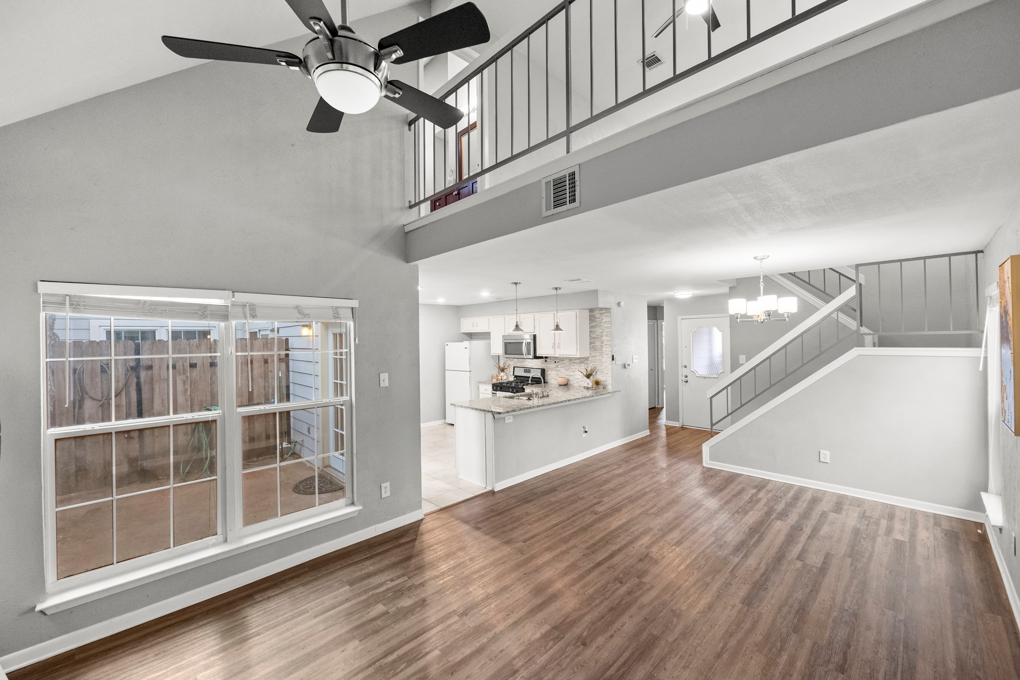 8330 Fathom Circle, Unit 501 Austin, TX 78750 - Photo 5 of 26 a view of a kitchen with wooden floor and a ceiling fan