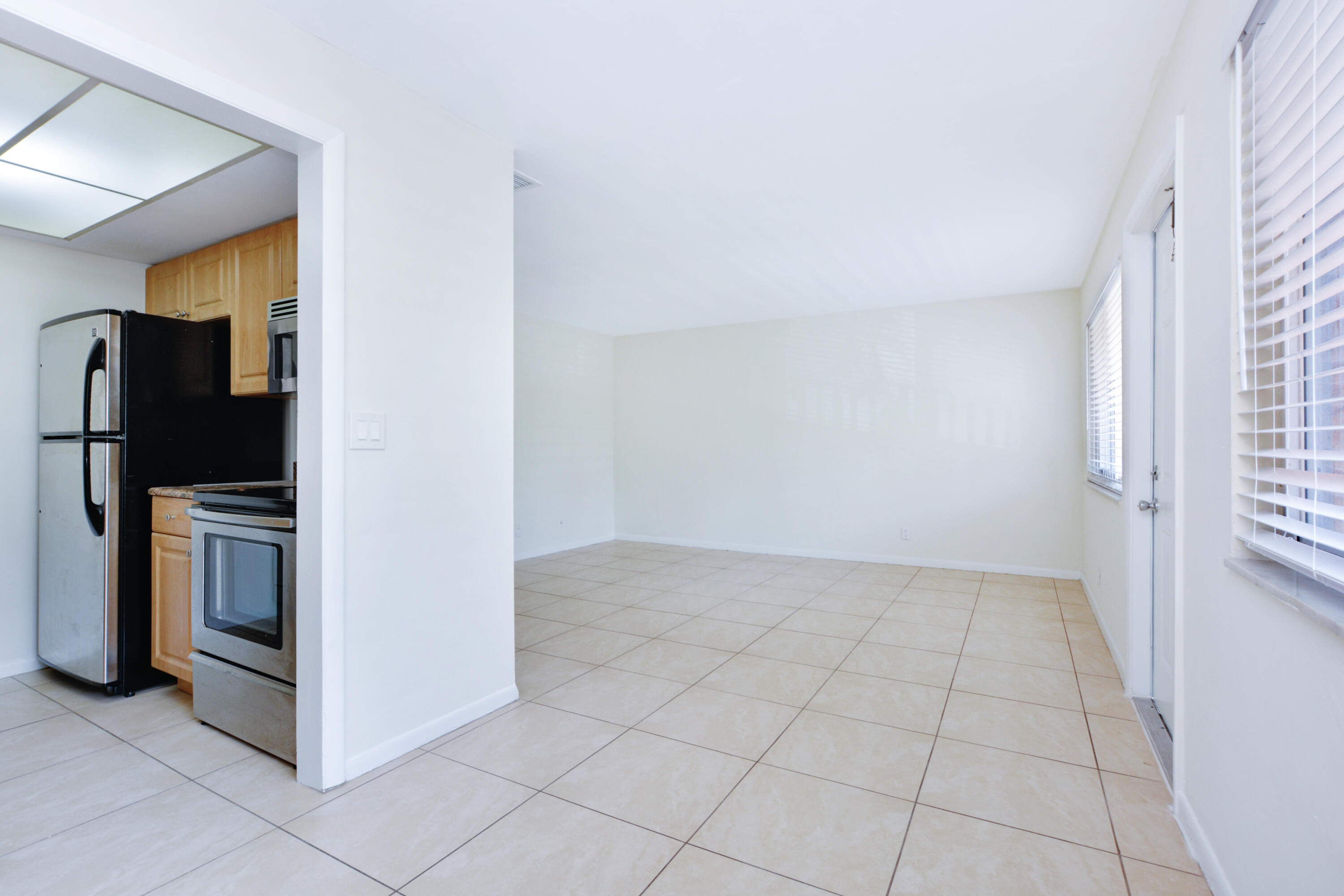 1000 Northeast 9th Avenue, Unit 8 Delray Beach, FL 33483 - Photo 4 of 10 a view of a refrigerator in kitchen and a window