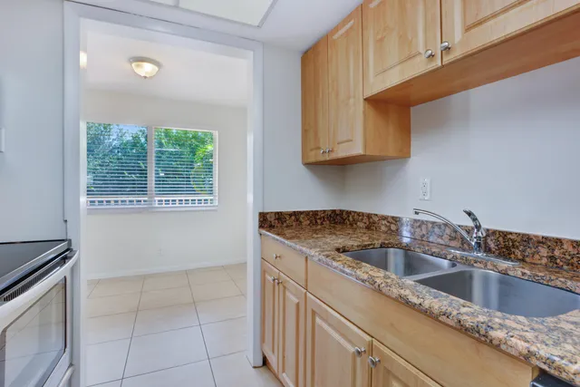a kitchen with a sink cabinets and window