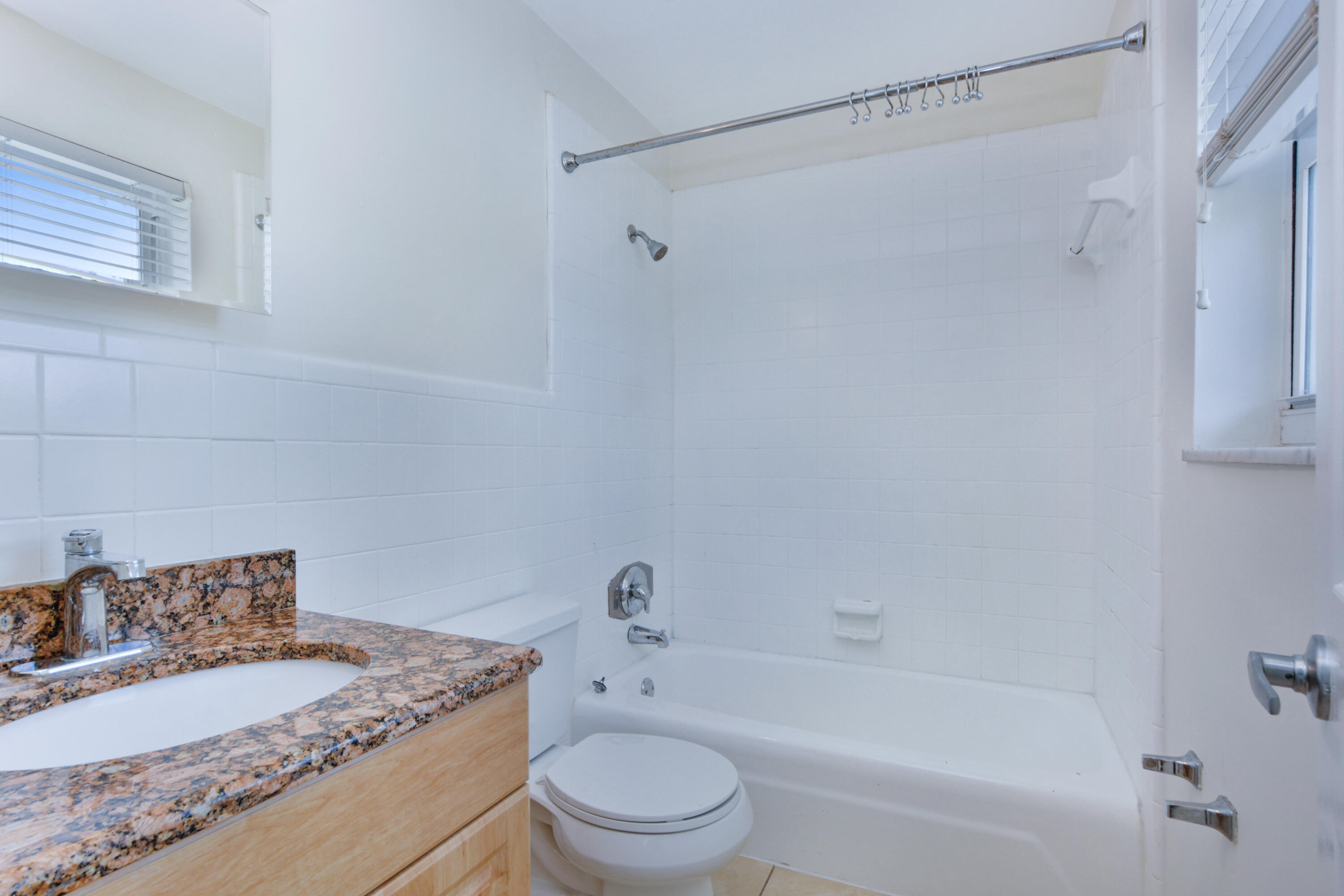1000 Northeast 9th Avenue, Unit 8 Delray Beach, FL 33483 - Photo 10 of 10 a bathroom with a granite countertop sink a toilet and shower