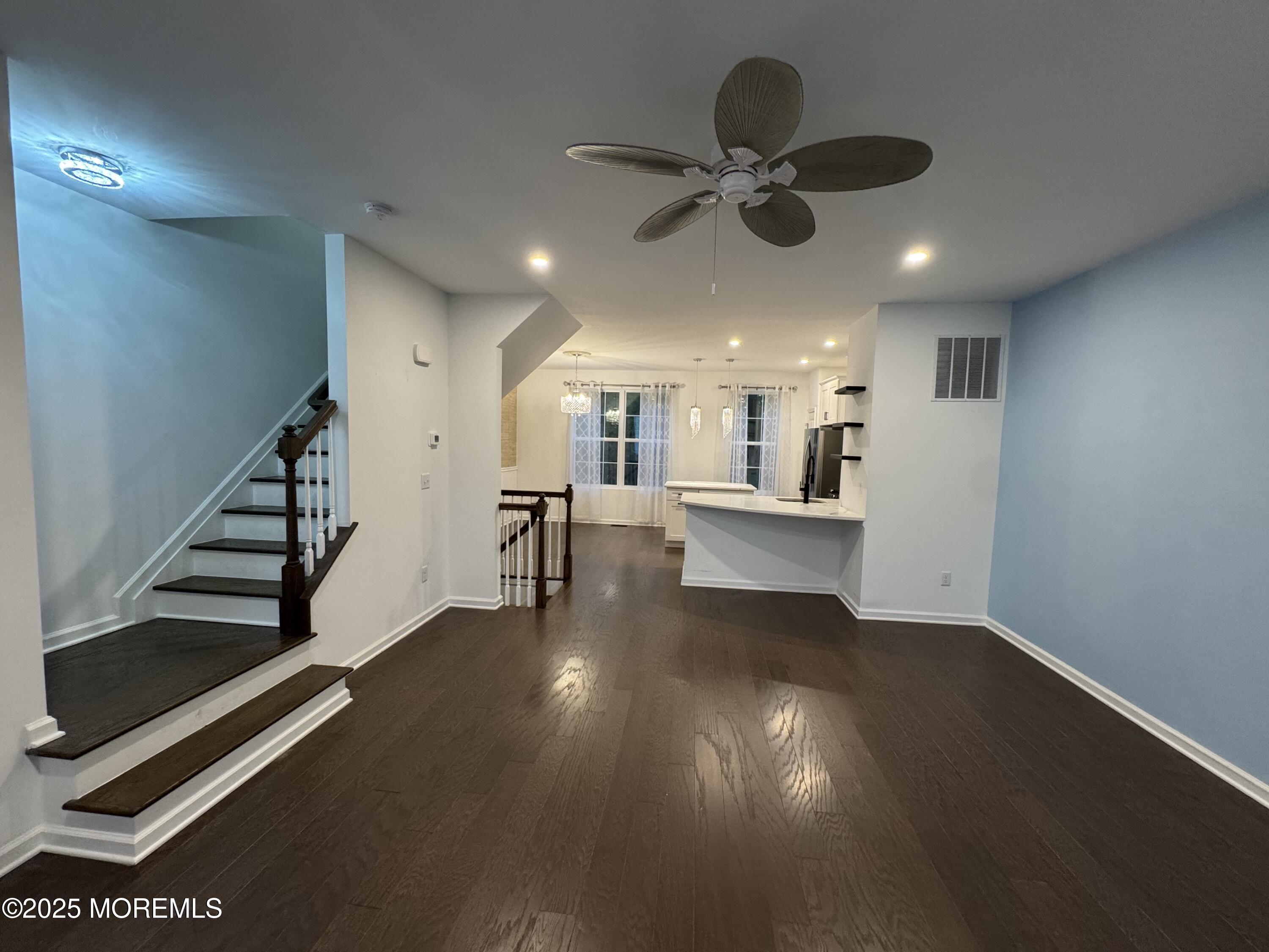 208 Revival Road Brick, NJ 08723 - Photo 11 of 24 a view of a living room with wooden floor and stairs