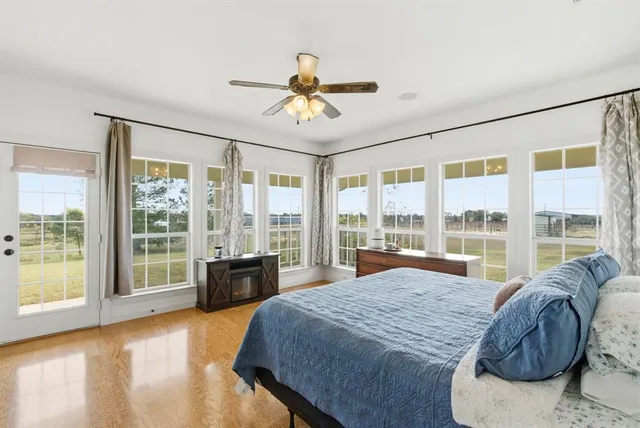 a spacious bedroom with a large bed and a large window