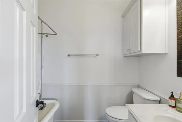 a bathroom with a toilet and a tub