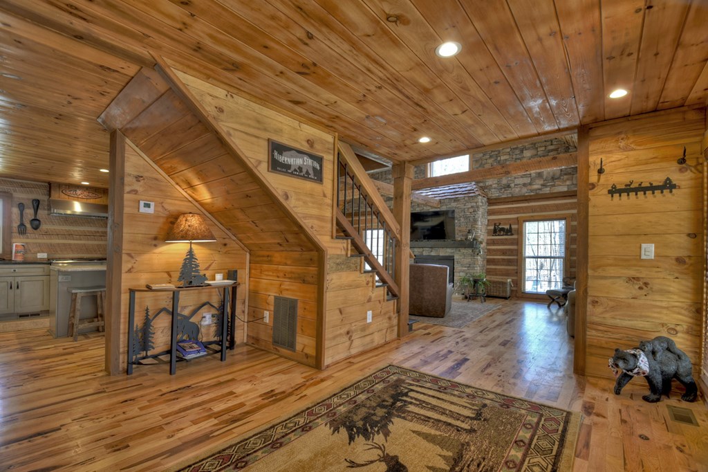 1276 Timber Lake Road Blue Ridge, GA 30513 - Photo 25 of 50 a view of a hallway with wooden floor and staircase