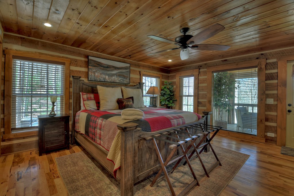 1276 Timber Lake Road Blue Ridge, GA 30513 - Photo 32 of 50 a bed sitting in a spacious bedroom next to a window