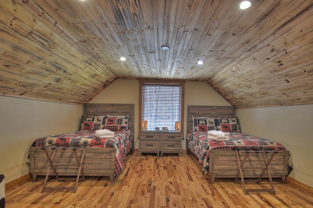 1276 Timber Lake Road Blue Ridge, GA 30513 - Photo 36 of 50 a bedroom with furniture and wooden floor