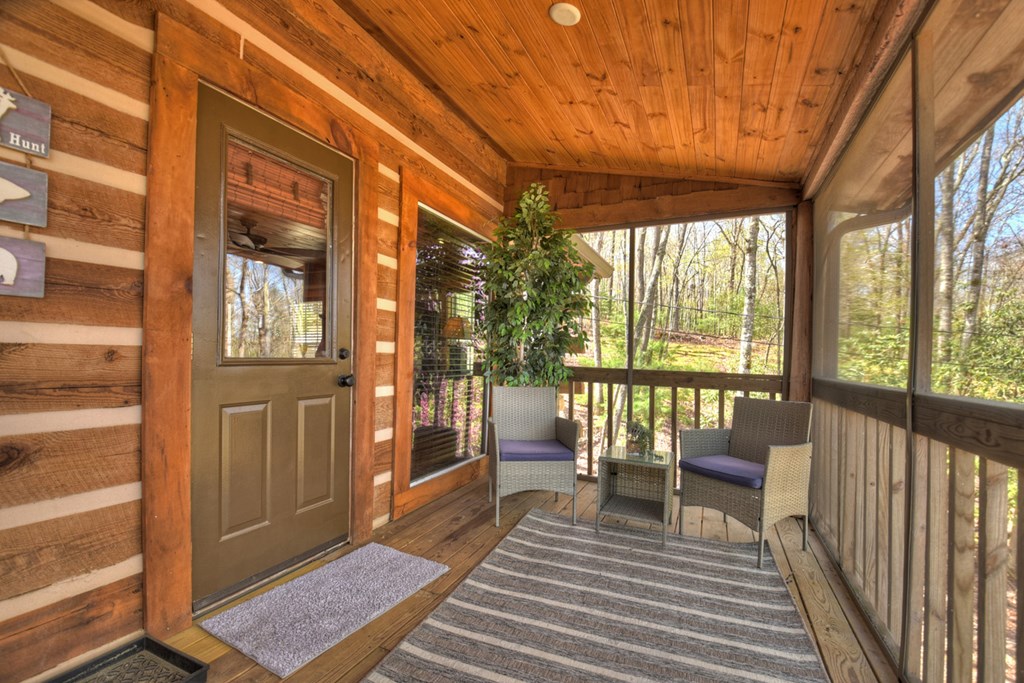 1276 Timber Lake Road Blue Ridge, GA 30513 - Photo 10 of 50 a balcony with wooden floor and furniture