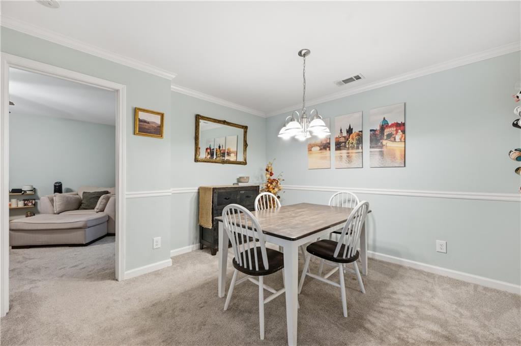 1007 Olde Mill Lane Norcross, GA 30093 - Photo 12 of 32 a view of a dining room with furniture and chandelier
