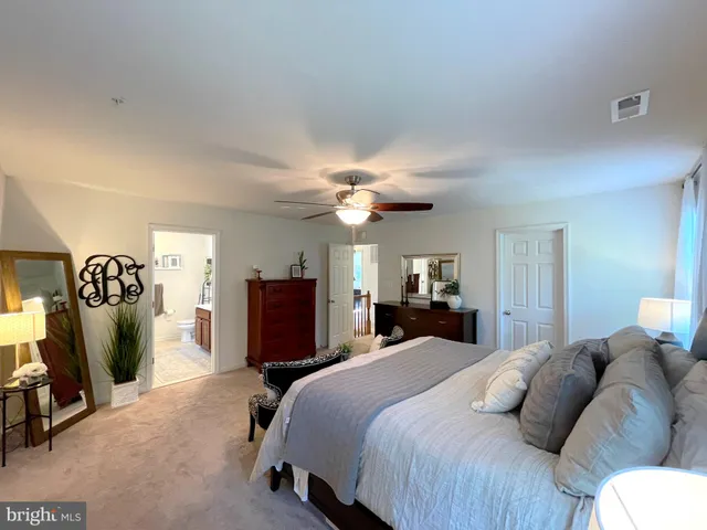 a bathroom with a sink a toilet a mirror and shower