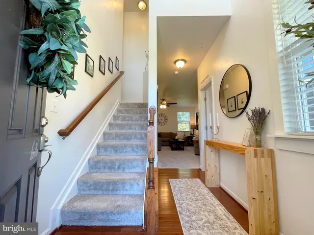 a room with lots of wooden furniture and a potted plant