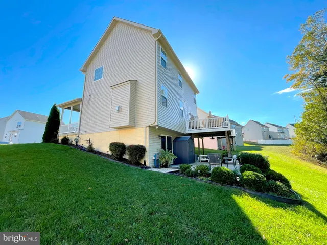 a view of a porch with furniture and a yard