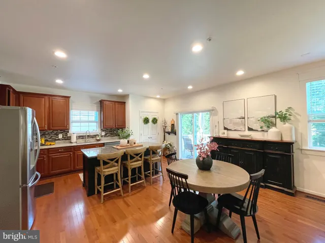 a living room with furniture kitchen view and a window