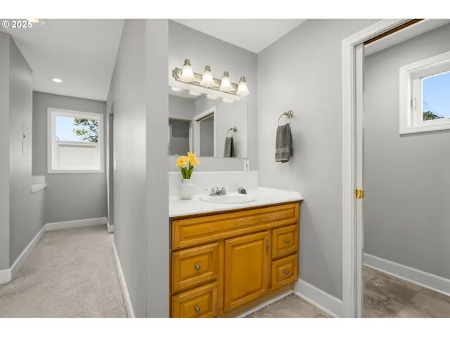 a bathroom with a sink vanity and mirror