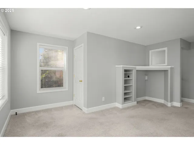 a view of an empty room with a closet