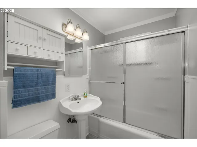 a bathroom with a sink mirror and a shower