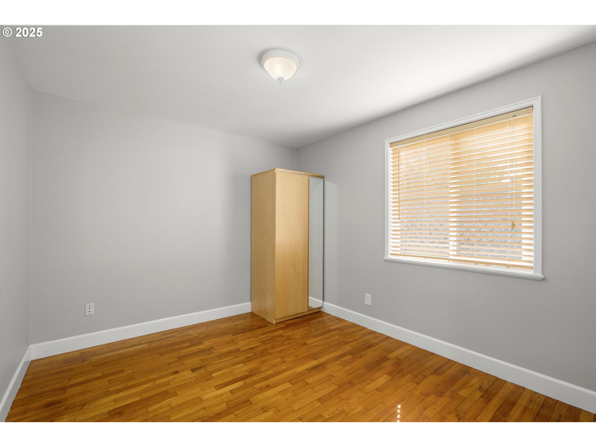 13120 Southwest Rita Drive Beaverton, OR 97005 - Photo 17 of 27 a view of an empty room with wooden floor and a window