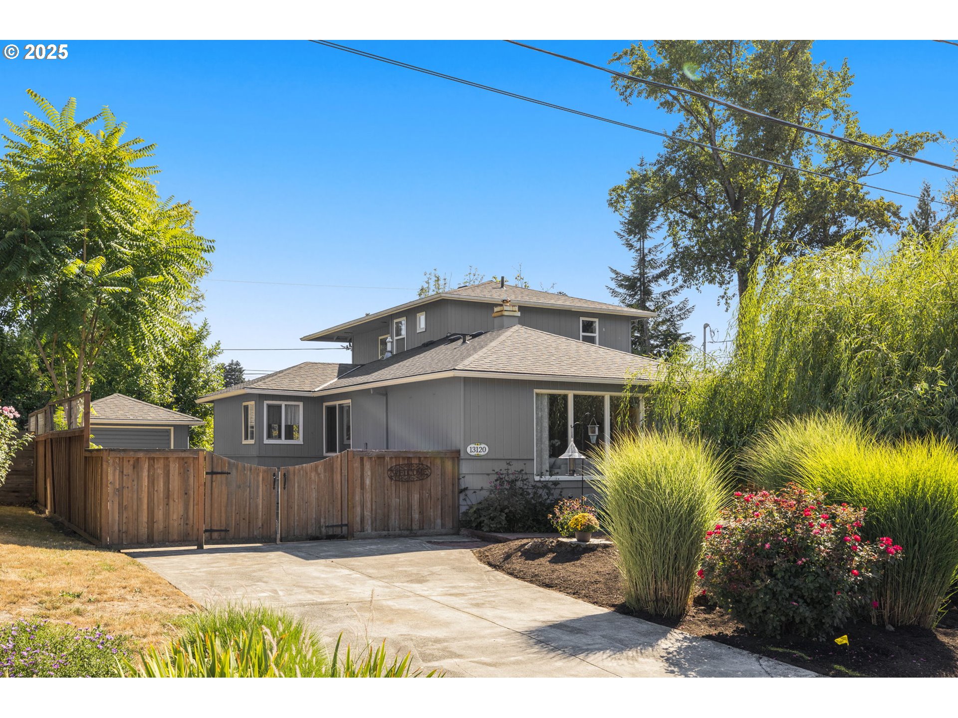 13120 Southwest Rita Drive Beaverton, OR 97005 - Photo 21 of 27 a view of a house with a small yard and potted plants