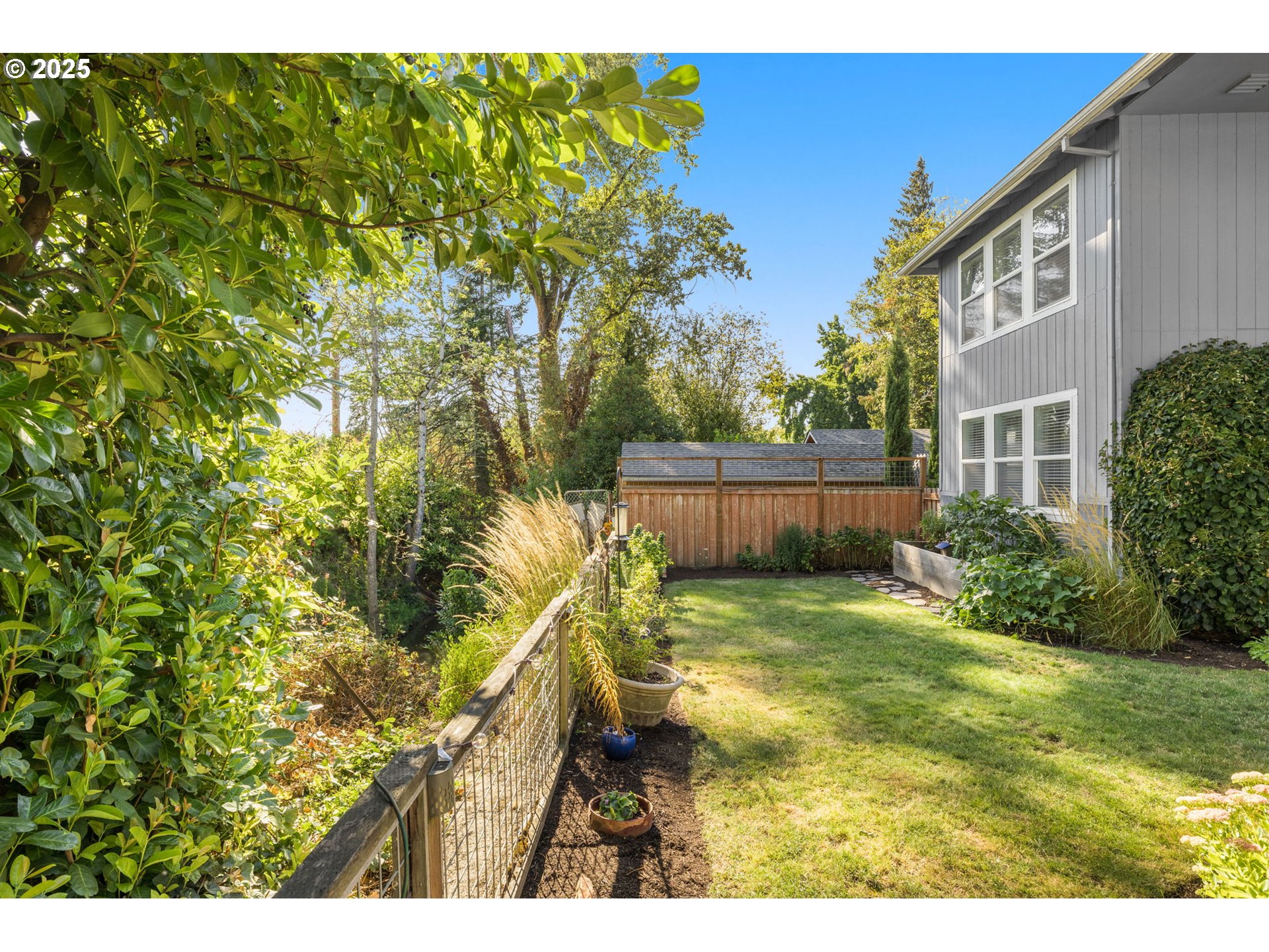 13120 Southwest Rita Drive Beaverton, OR 97005 - Photo 24 of 27 a backyard of a house with lots of green space