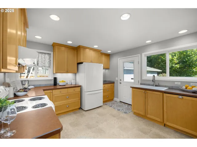 a kitchen with sink cabinets and window