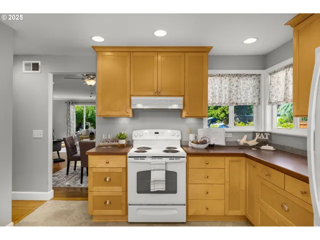 a kitchen with a sink a stove and cabinets