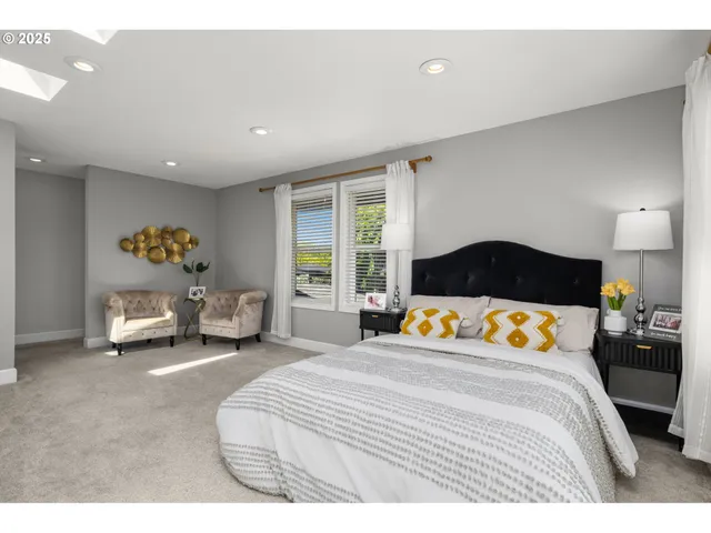 a bedroom with a bed and a large window