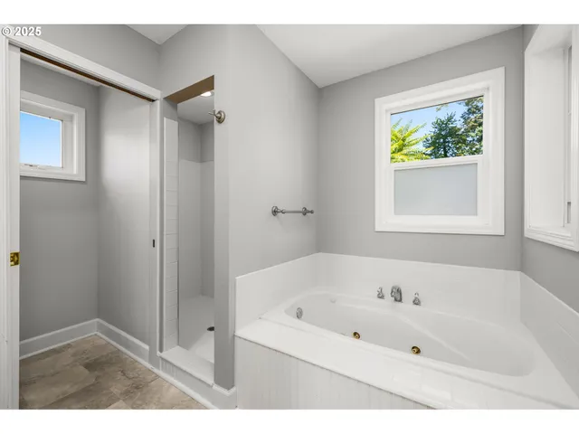 a white bath tub sitting next to a window