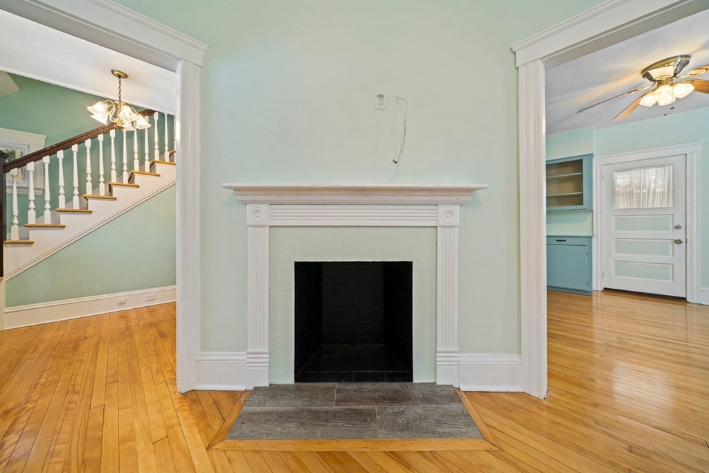 44 Beaconsfield Road Worcester, MA 01602 - Photo 4 of 32 a view of a livingroom with wooden floor and a fireplace