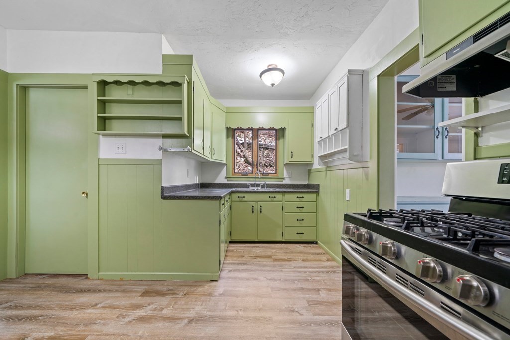 44 Beaconsfield Road Worcester, MA 01602 - Photo 10 of 32 a kitchen with a stove and a refrigerator