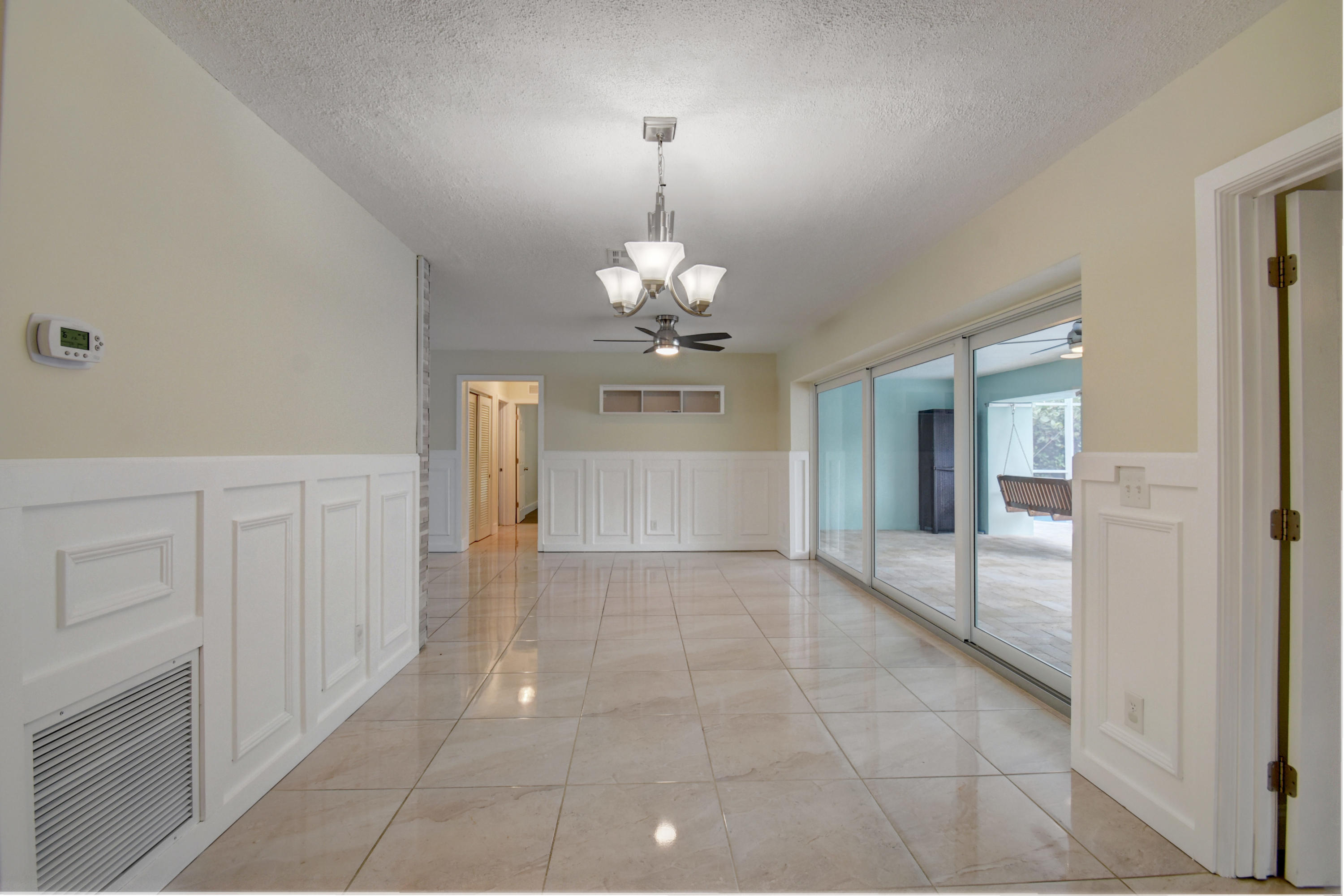1266 Southwest 5th Street Boca Raton, FL 33486 - Photo 10 of 30 a view of a livingroom with a chandelier fan and windows
