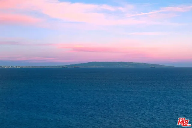 a view of a field with an ocean