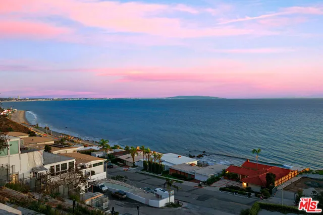 a view of a terrace with lawn chairs
