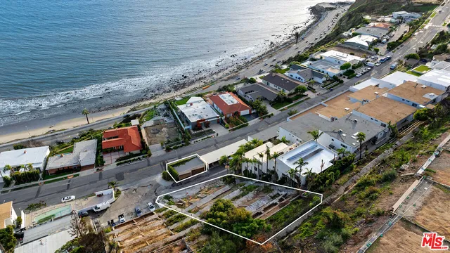 an aerial view of a chairs and table on the roof