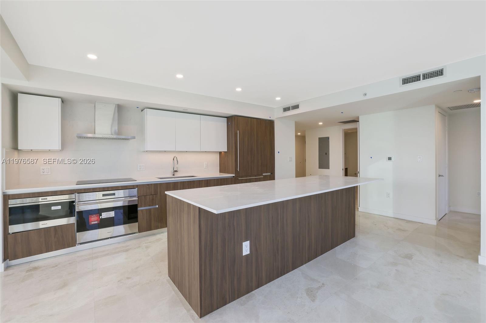 1500 Bay Road, Unit N0516 Miami Beach, FL 33139 - Photo 14 of 88 a kitchen with stainless steel appliances granite countertop a sink counter space and cabinets
