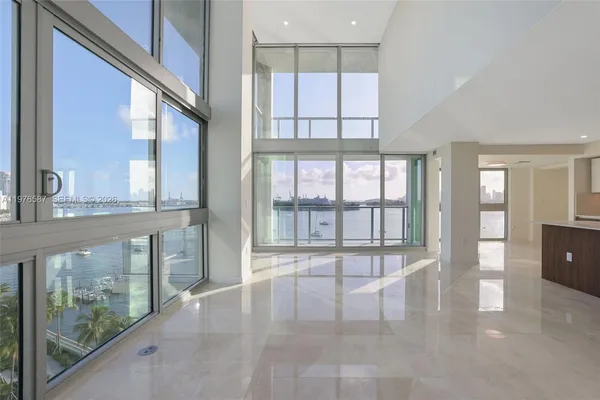 a large white kitchen with a large window