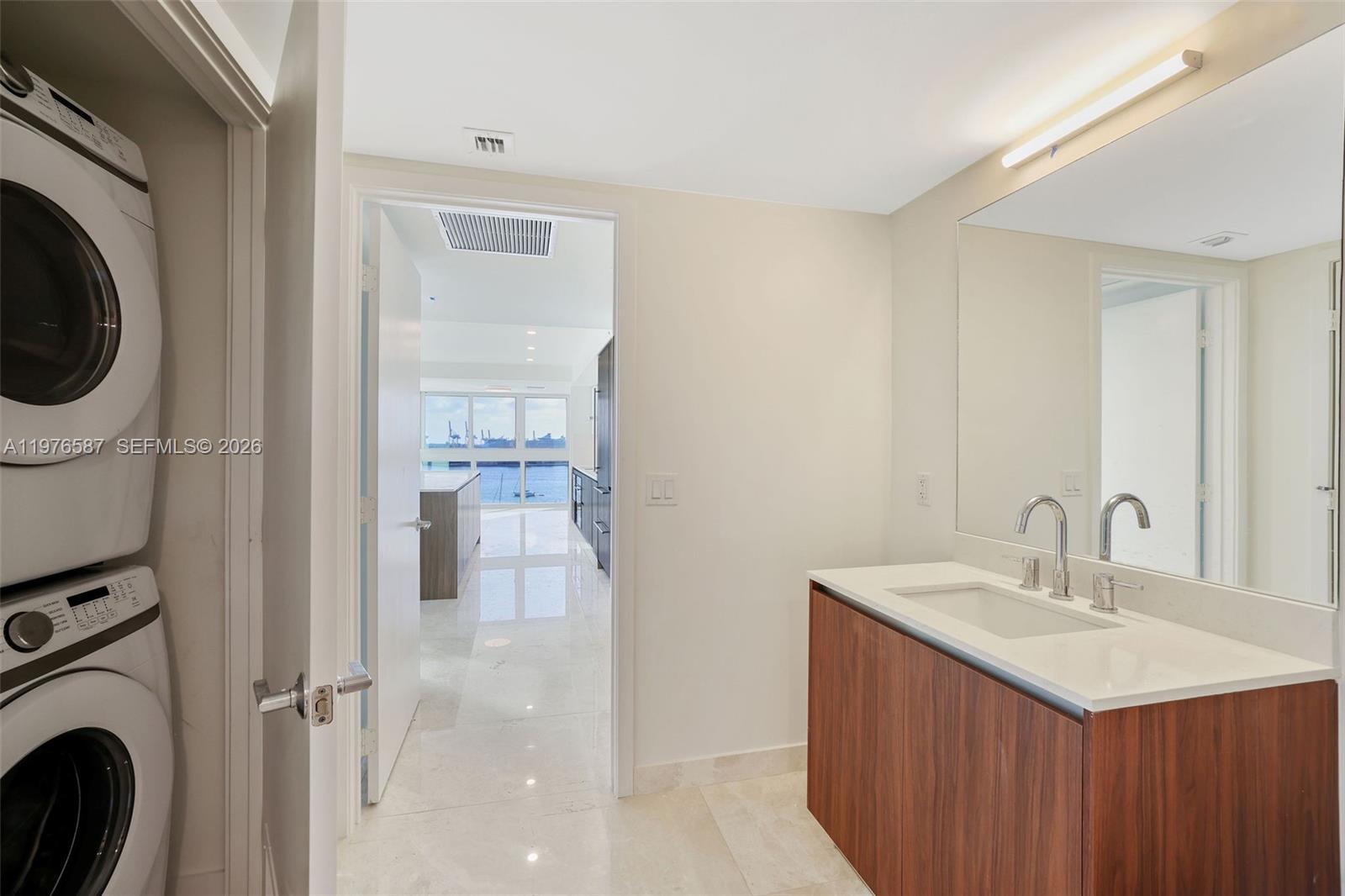 1500 Bay Road, Unit N0516 Miami Beach, FL 33139 - Photo 21 of 88 a bathroom with a sink a mirror and a shower