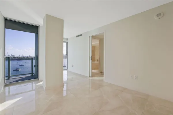 a view of a swimming pool with a patio and a yard