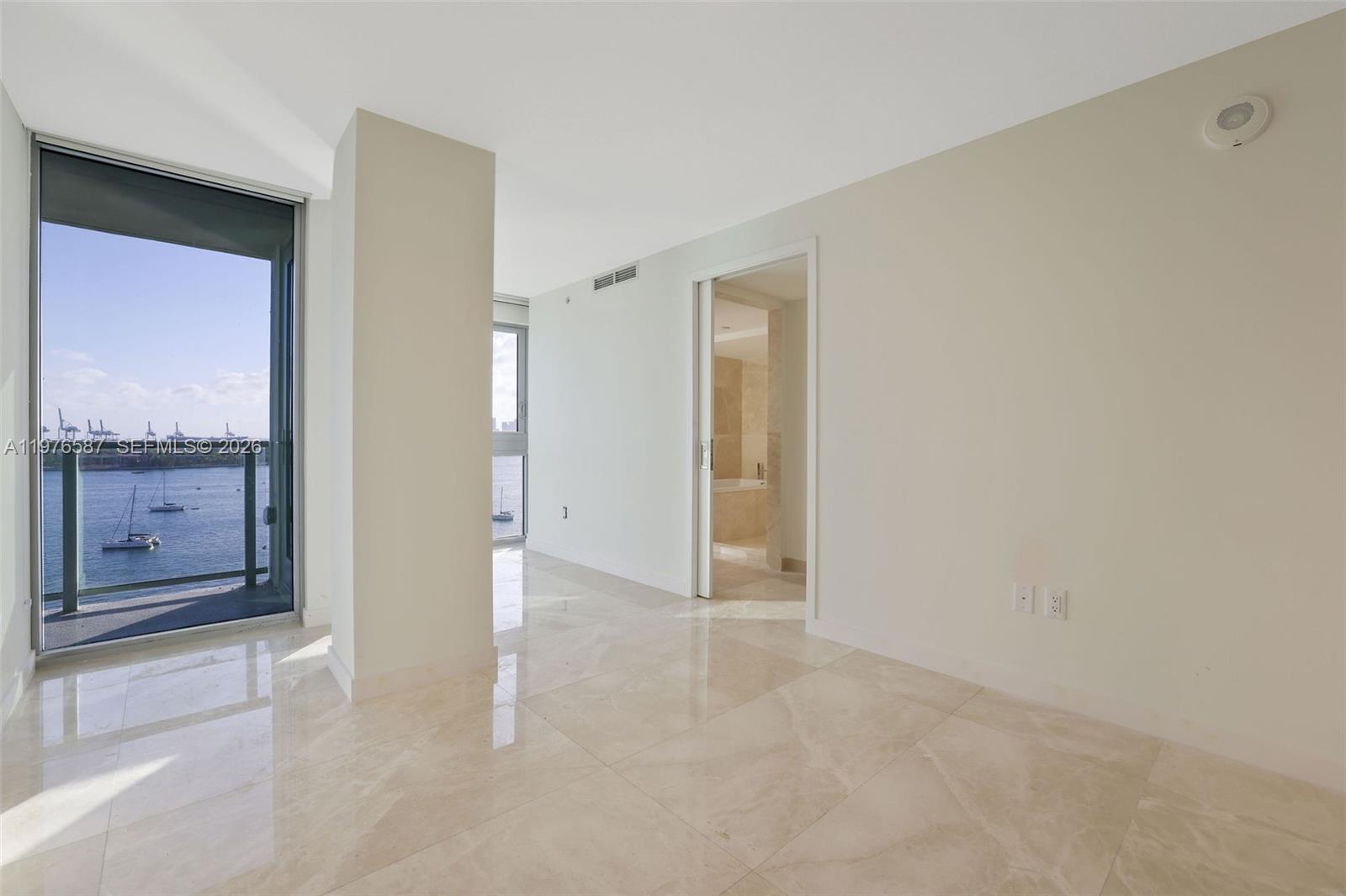 1500 Bay Road, Unit N0516 Miami Beach, FL 33139 - Photo 25 of 88 an empty room with cabinet and mirrors