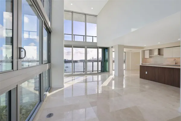 a view of a kitchen with a sink and a refrigerator