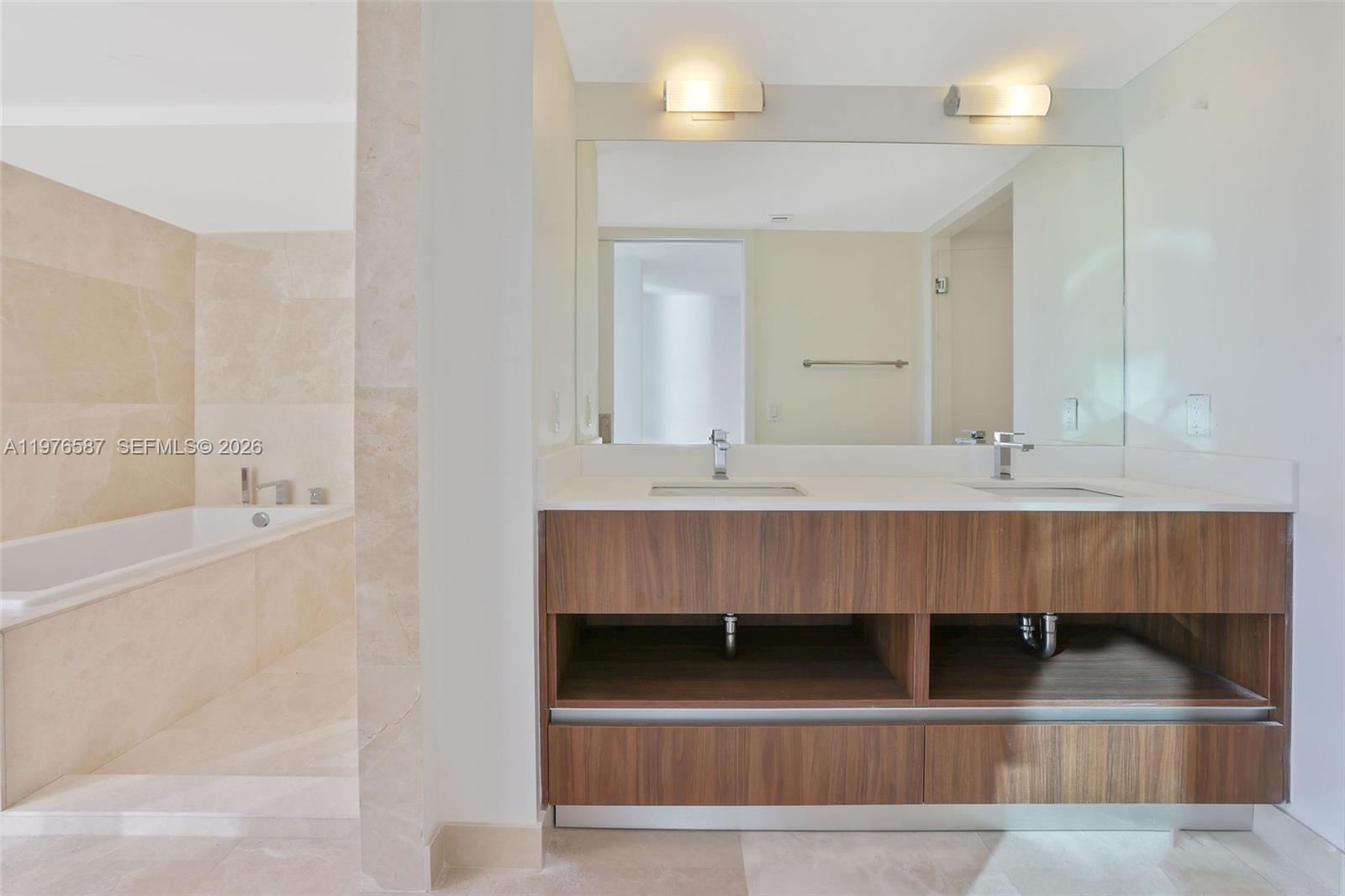 1500 Bay Road, Unit N0516 Miami Beach, FL 33139 - Photo 33 of 88 a bathroom with a sink and a mirror