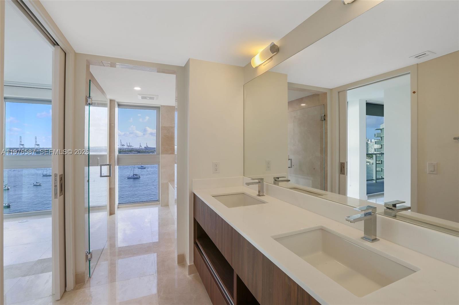 1500 Bay Road, Unit N0516 Miami Beach, FL 33139 - Photo 35 of 88 a bathroom with a sink and a mirror