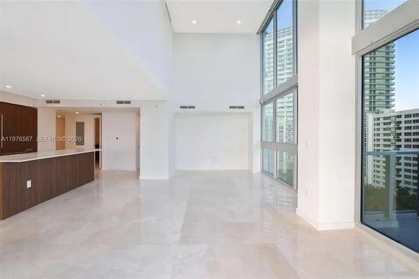 an empty room with cabinet and mirrors