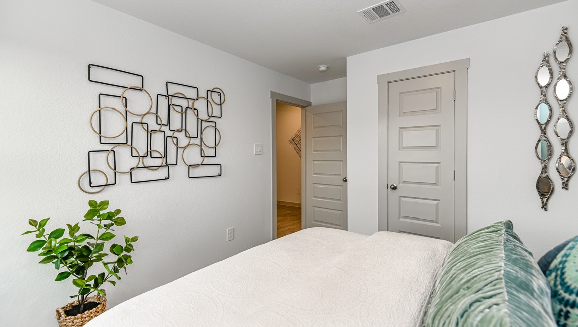 7918 Murciana Drive Rosharon, TX 77583 - Photo 7 of 21 a bedroom with a bed and a plant