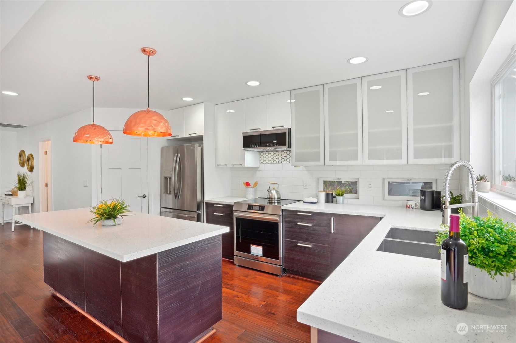 7453 Gatewood Road Southwest Seattle, WA 98136 - Photo 11 of 40 a large kitchen with stainless steel appliances kitchen island granite countertop a stove a sink a oven and a white cabinets