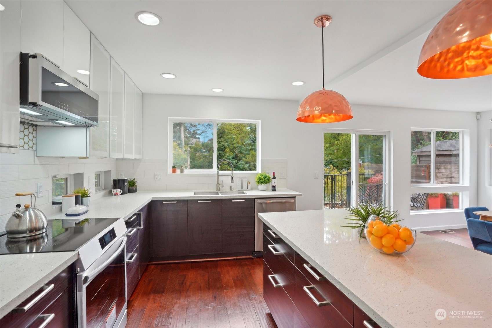 7453 Gatewood Road Southwest Seattle, WA 98136 - Photo 12 of 40 a kitchen with a sink a stove and a wooden floor