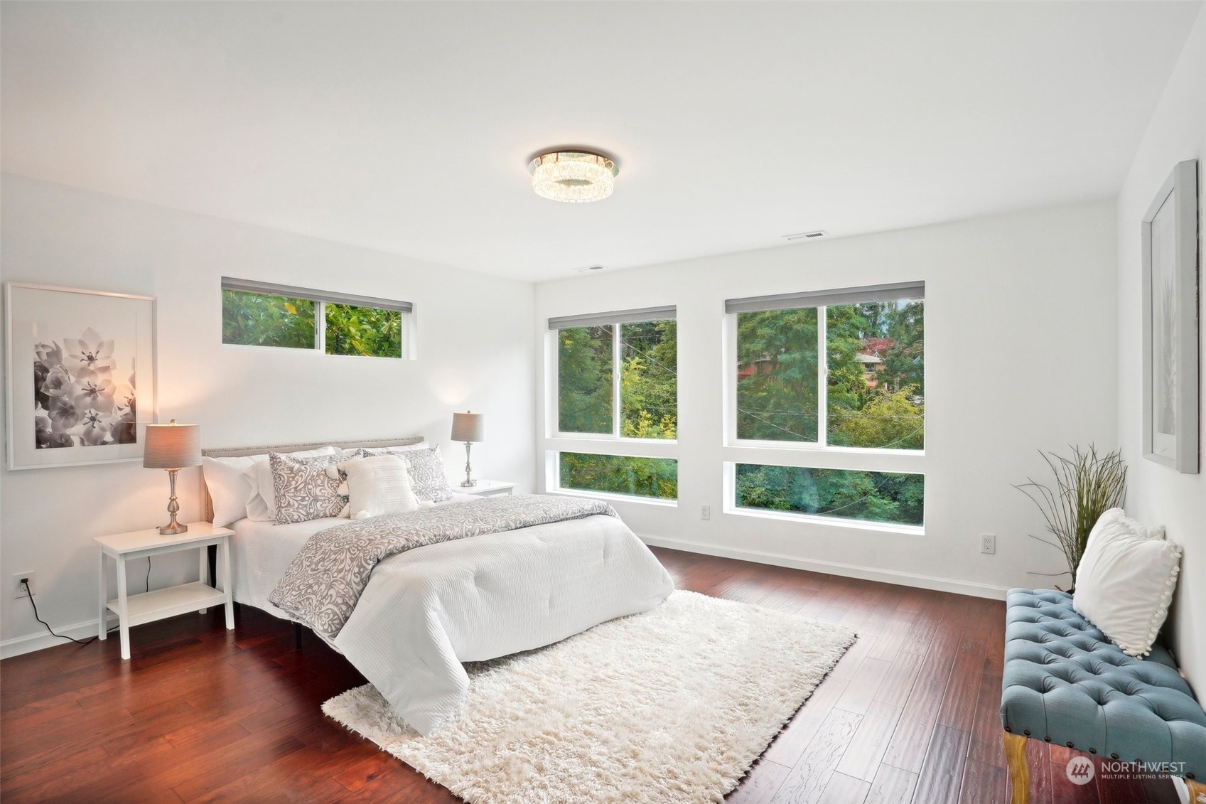 7453 Gatewood Road Southwest Seattle, WA 98136 - Photo 19 of 40 a spacious bedroom with a bed and wooden floor