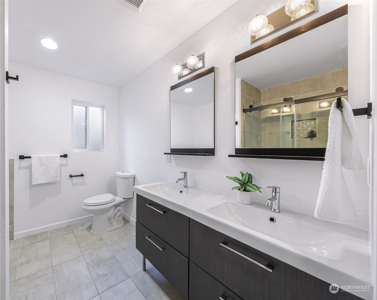 7453 Gatewood Road Southwest Seattle, WA 98136 - Photo 22 of 40 a bathroom with a toilet sink and mirror