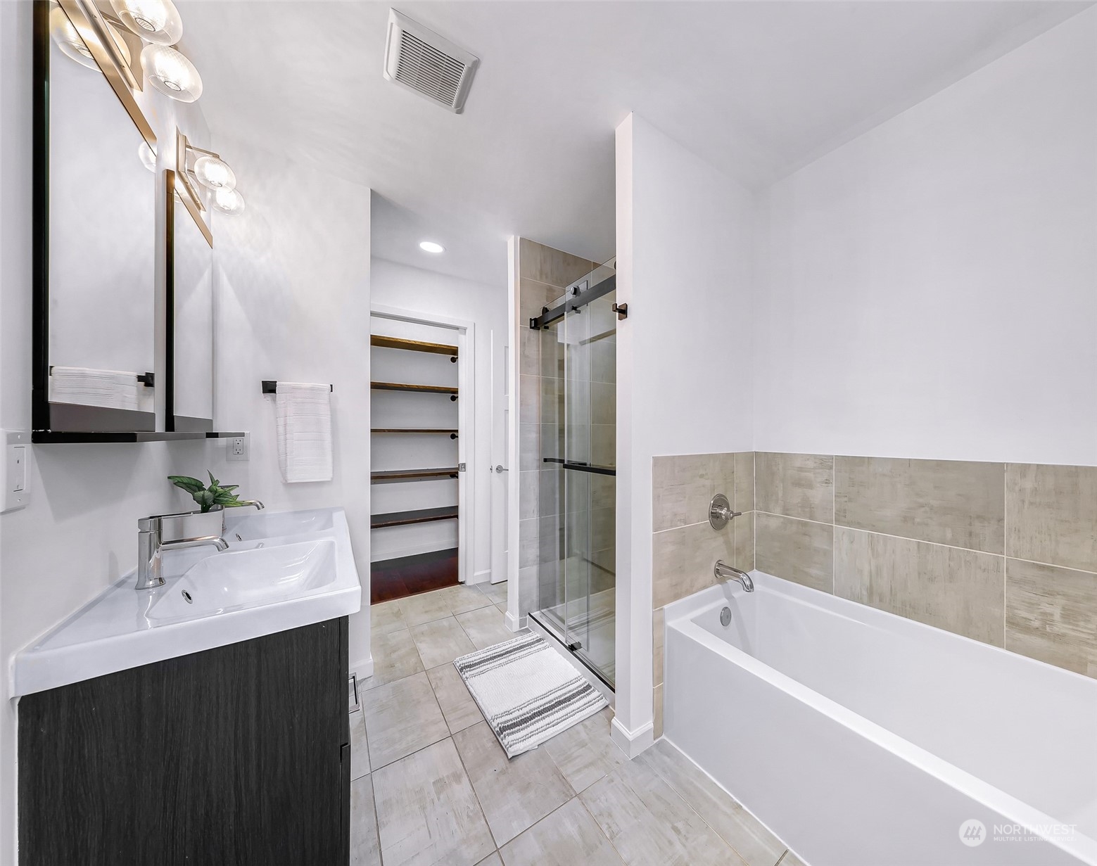 7453 Gatewood Road Southwest Seattle, WA 98136 - Photo 23 of 40 a bathroom with a bath tub a sink and a mirror