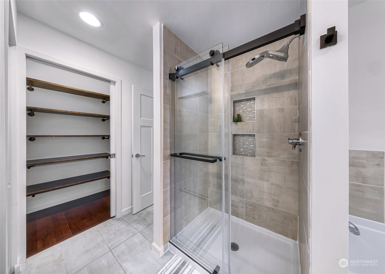 7453 Gatewood Road Southwest Seattle, WA 98136 - Photo 24 of 40 a bathroom with a glass shower door
